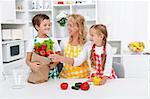 Healthy nutrition concept with people in the kitchen unpacking the vegetables from grocery bag