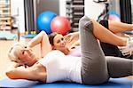 Women Doing Stretching Exercises In Gym