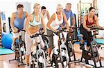 Group Of People In Spinning Class In Gym