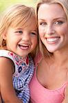 Portrait Of Mother And Child Relaxing In Park