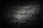 Dark brick wall with  light area