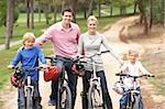 Family enjoying bike ride in park