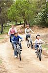 Family enjoying bike ride in park