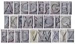 English alphabet - a collage of 26 isolated letters in grunge letterpress metal type, scratched and stained by ink