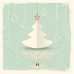 Simple paper Christmas tree with star and hanging ornaments on pale green distressed background.