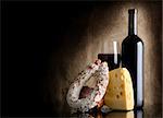 Wine bottle and cheesei on a background of old canvas