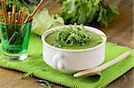 Cream soup  broccoli with arugula greens in a white bowl