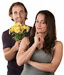 Smiling woman and comforting man holding flowers