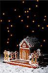Gingerbread house in the snow under starry sky - christmas setting with copy space