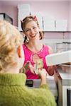 Woman Wearing Devil Horns Working at a Bakery, Oakland, Alameda County, California, USA