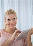 Smiling woman using tablet computer