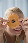 Woman peering through donut hole