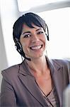 Businesswoman wearing headset at desk