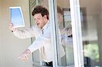 Businessman shouting from office window