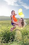 Sisters playing in field of flowers