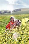 Sisters playing in field of flowers