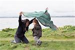 Mother and son playing in grassy field