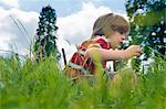 Boy playing in grassy field