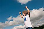 Girl with medal cheering outdoors