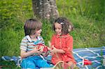 Girl giving gift at birthday picnic