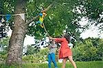 Children swinging at pinata at party