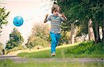 Boy running with balloon outdoors