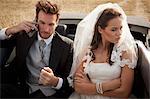 Newlywed couple arguing in car