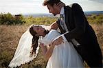 Newlywed couple dancing outdoors