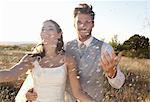 Newlywed couple walking in confetti