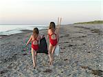 Girls walking on sandy beach