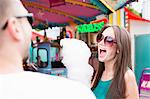 Woman eating cotton candy at fair