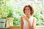 Smiling woman drinking glass of water