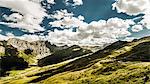 Clouds over grassy rural landscape