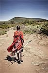 Maasai man walking on dirt road