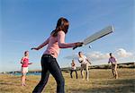 Family playing cricket together outdoors