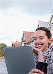 Woman using tablet computer outdoors