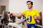 Man using exercise equipment at gym