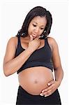 Young pregnant woman think with hand on chin over white background
