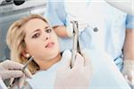Young Woman looking at Dental Instruments during Appointment, Germany