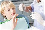 Boy declining Needle at Dentist's Office during Appointment, Germany