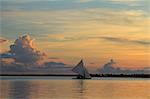 Boat sailing at sunrise, Kaohagan Island, Philippines