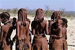 Rear-View of Himba Tribe Standing Outdoors Namibia, Africa