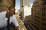 Business Man on Balcony with Cell Phone, Johannesburg, Gauteng, South Africa