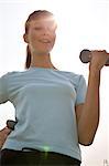 Young woman with dumbbells