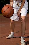 Young woman playing basketball