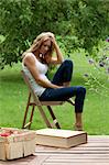 Young woman sitting in garden