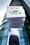 Man with pizza boxes in front of his face