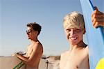 Two young men with surfboards