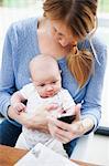 Mother with newborn baby and cell phone