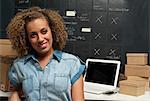 Woman in home office with cardboard boxes